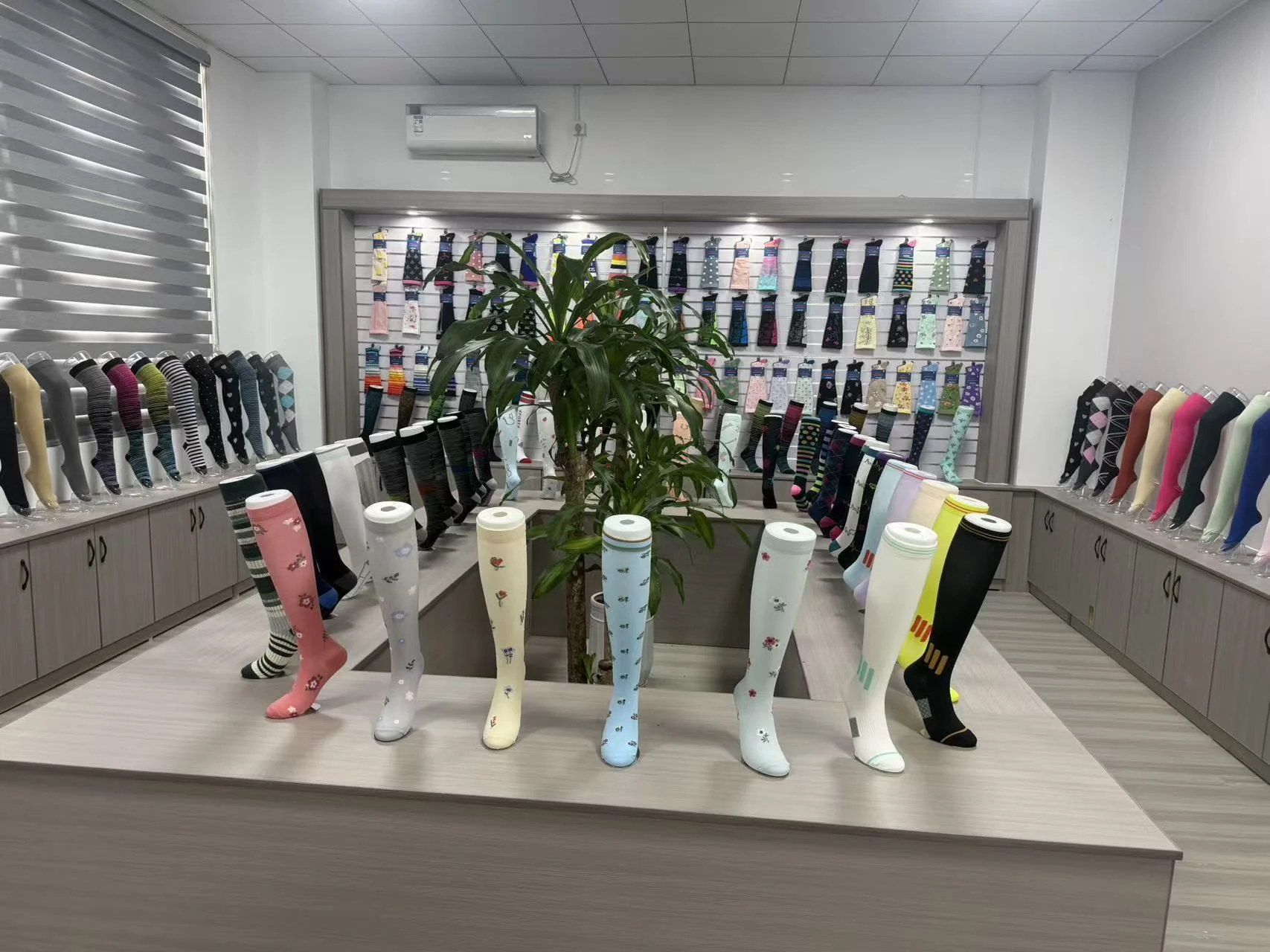 Compression sock factory showroom with product samples displayed for buyers